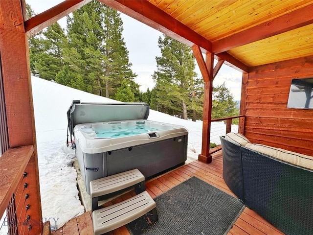 wooden deck with a hot tub