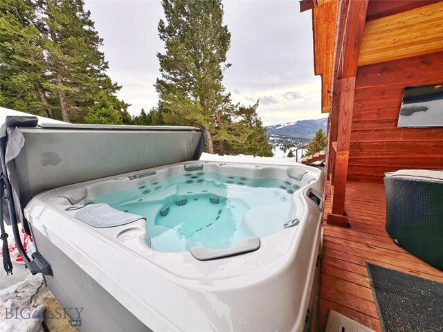 exterior space featuring a mountain view and a hot tub