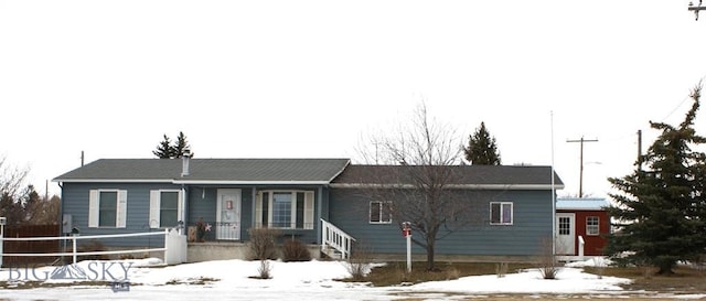 ranch-style home featuring fence and covered porch