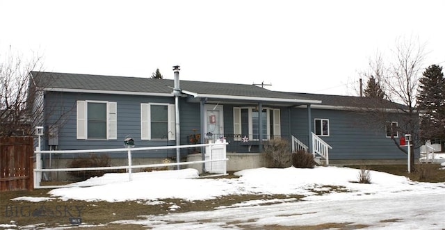 ranch-style home with covered porch and fence