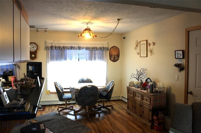 office area with a textured ceiling, baseboard heating, and wood finished floors