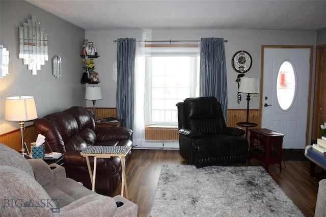 living room featuring a wainscoted wall, wood finished floors, and wood walls