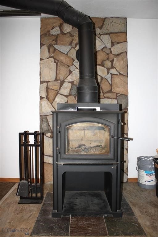 interior details featuring a wood stove and baseboards