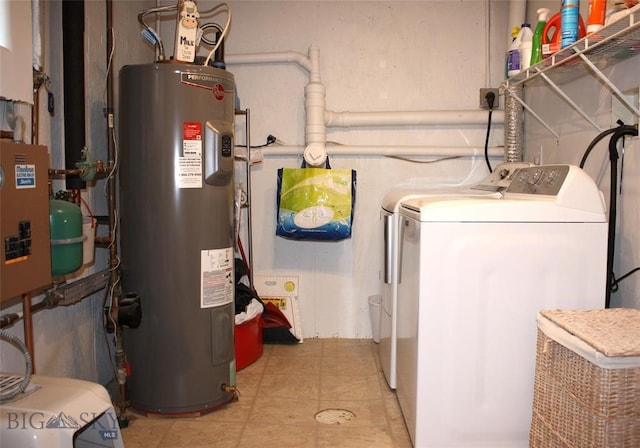 clothes washing area with light tile patterned floors, independent washer and dryer, and water heater