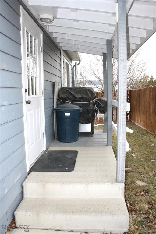 exterior space with area for grilling and fence