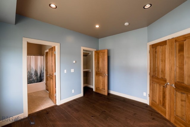 284 Annie Glade, Bozeman, MT 59718 - unfurnished bedroom with dark wood-style floors, baseboards, recessed lighting, a walk in closet, and ensuite bathroom