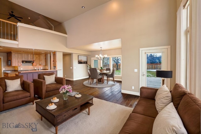 284 Annie Glade, Bozeman, MT 59718 - living room with baseboards, a high ceiling, a chandelier, dark wood-style floors, and ceiling fan