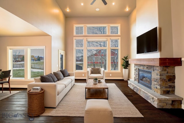 284 Annie Glade, Bozeman, MT 59718 - living room with a towering ceiling, a fireplace, dark wood-style flooring, baseboards, and recessed lighting
