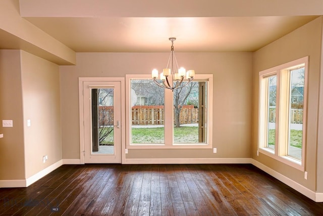 284 Annie Glade, Bozeman, MT 59718 - unfurnished dining area featuring a chandelier, baseboards, and dark wood-style flooring
