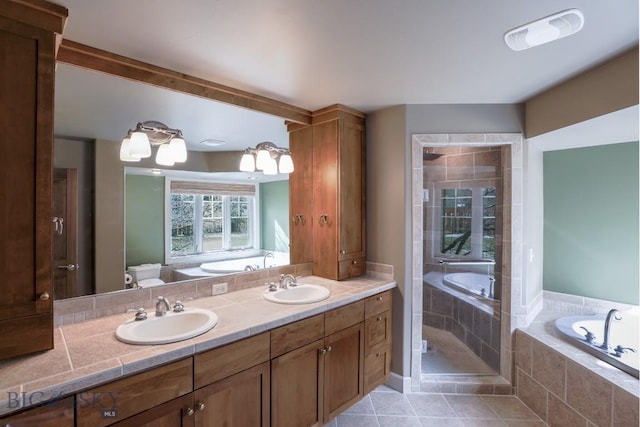 284 Annie Glade, Bozeman, MT 59718 - full bath featuring a garden tub, double vanity, tile patterned floors, and toilet