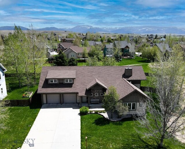 284 Annie Glade, Bozeman, MT 59718 - view of front of property featuring driveway, an attached garage, a residential view, a front yard, and a mountain view