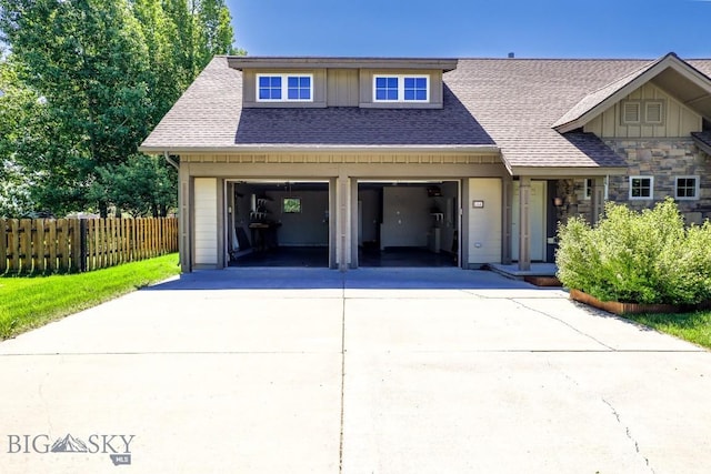 284 Annie Glade, Bozeman, MT 59718 - view of front of home with concrete driveway, a garage, a shingled roof, and stone siding