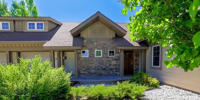 284 Annie Glade, Bozeman, MT 59718 - view of front of property with board and batten siding, roof with shingles, and stone siding