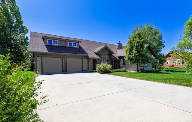 284 Annie Glade, Bozeman, MT 59718 - view of front facade featuring concrete driveway, stone siding, a front lawn, and a chimney