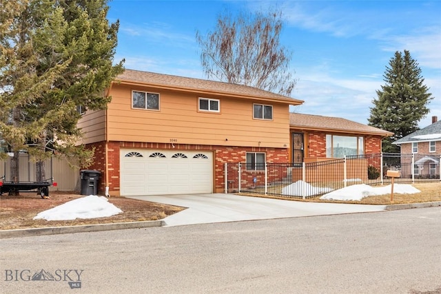 view of front of property with brick siding, a garage, fence, and driveway