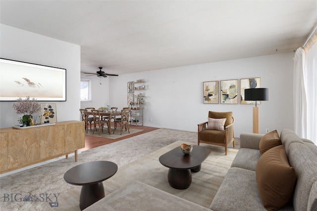 carpeted living room with a ceiling fan