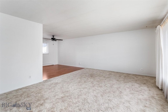 spare room featuring carpet and a ceiling fan