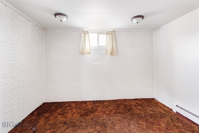 unfurnished room featuring a baseboard heating unit, carpet floors, and brick wall