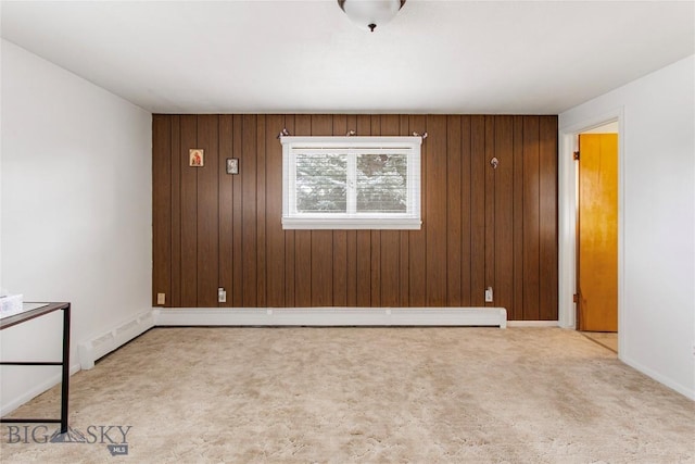 unfurnished room with baseboards, wood walls, and carpet flooring