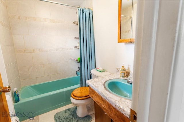 full bath with tile patterned floors, vanity, toilet, and shower / bath combo with shower curtain