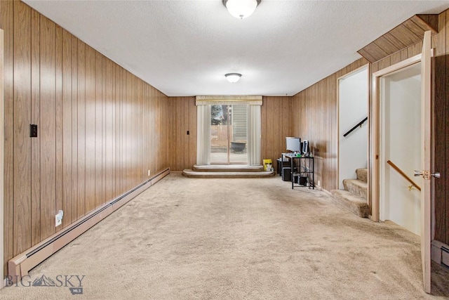 unfurnished room with a textured ceiling, stairway, carpet floors, and a baseboard radiator