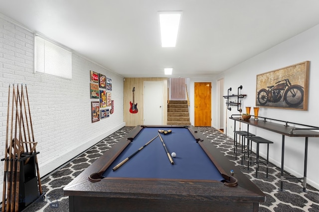 rec room with pool table, carpet flooring, and brick wall