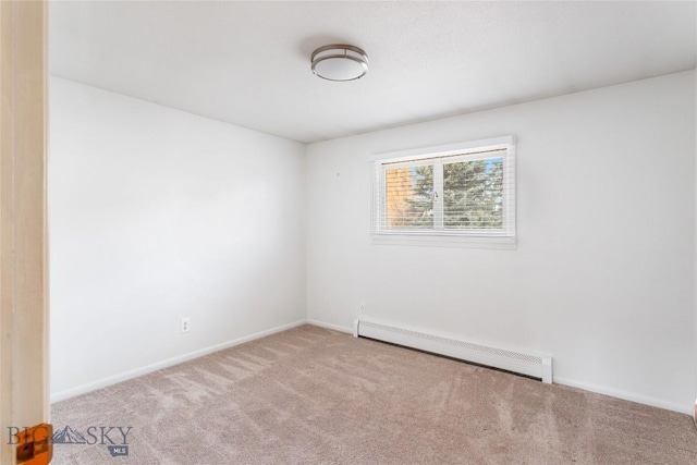 unfurnished room featuring a baseboard radiator, carpet floors, and baseboards