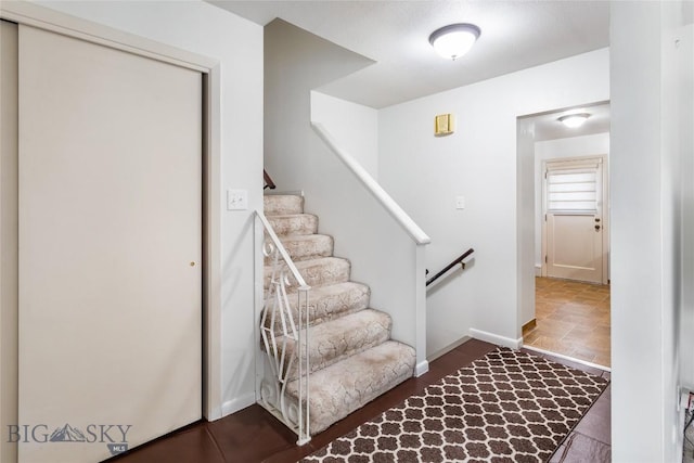 stairway featuring baseboards