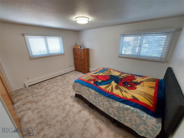 bedroom featuring carpet floors, a baseboard radiator, and baseboards