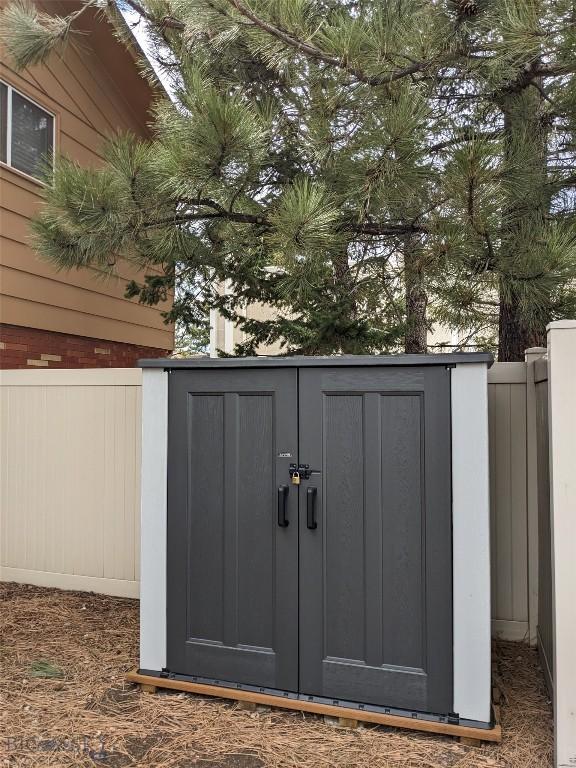 view of shed with fence