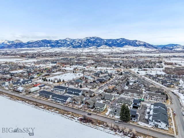 snowy aerial view featuring a mountain view