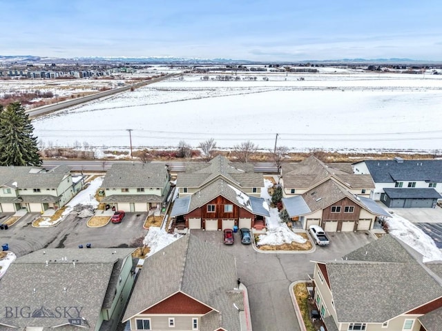 snowy aerial view with a residential view