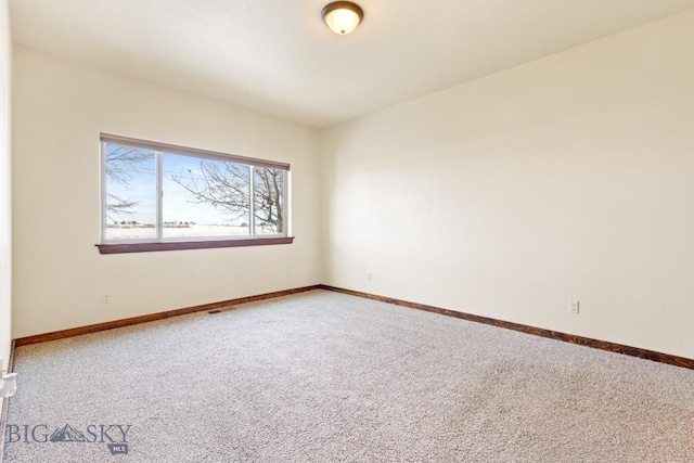 unfurnished room featuring carpet flooring and baseboards