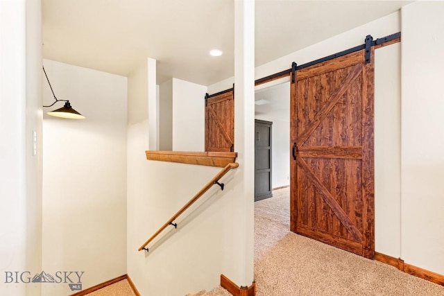 stairs with baseboards, carpet, and a barn door