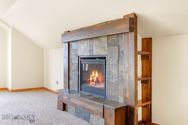 interior details featuring baseboards, carpet, and a tile fireplace