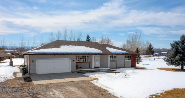 ranch-style home featuring an attached garage, covered porch, driveway, and a shingled roof