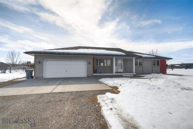 ranch-style home with concrete driveway, an attached garage, and a shingled roof