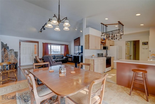 dining room featuring lofted ceiling, recessed lighting, and a chandelier