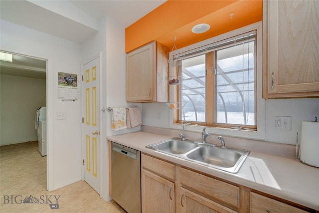 kitchen with washer and dryer, light brown cabinets, a sink, light countertops, and stainless steel dishwasher