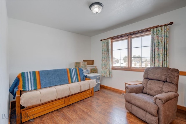 sitting room featuring baseboards and wood finished floors