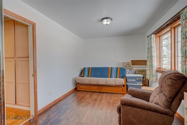 bedroom with baseboards and wood finished floors