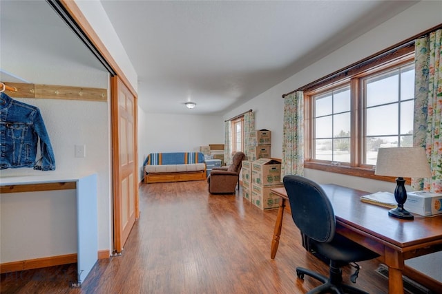 home office with baseboards, plenty of natural light, and wood finished floors