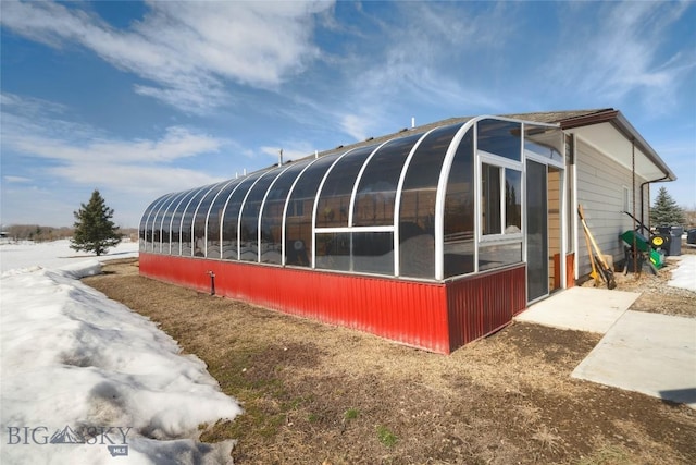 view of home's exterior with a sunroom