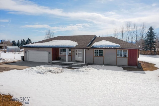 ranch-style house with driveway and a garage