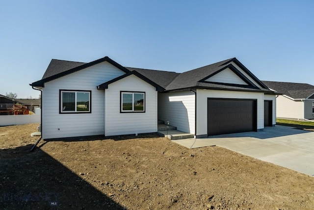 ranch-style home with concrete driveway and a garage