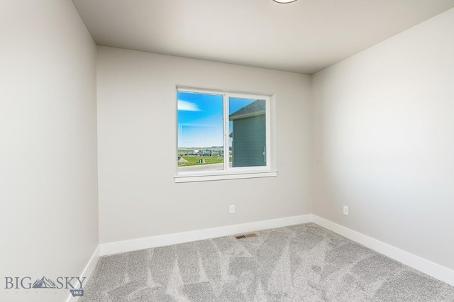 unfurnished room featuring visible vents, carpet flooring, and baseboards