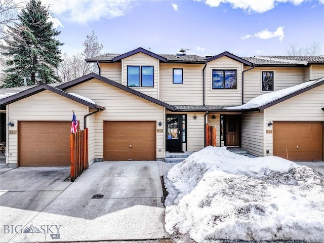 view of property featuring driveway and a garage