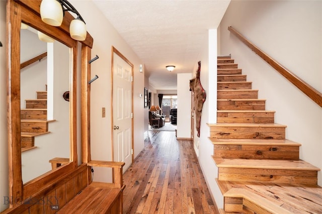 staircase featuring wood-type flooring