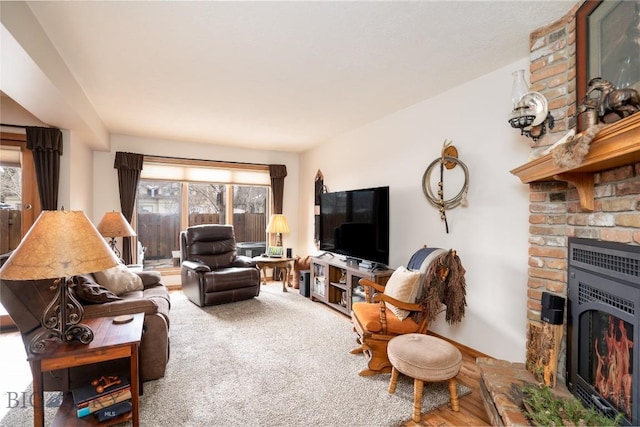 living area featuring heating unit, a fireplace, and carpet