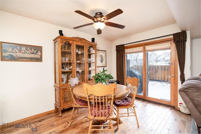 dining room with light wood-type flooring, baseboards, and a ceiling fan